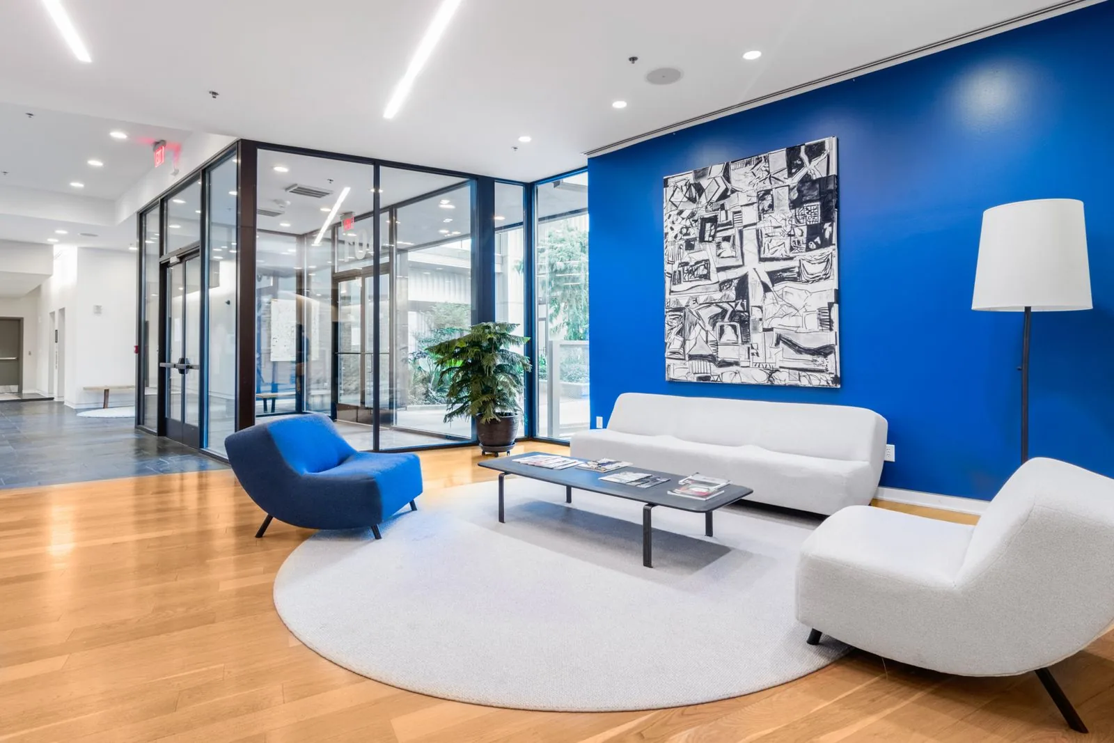 Bright, welcoming office reception lobby with a white sofa and blue accent wall